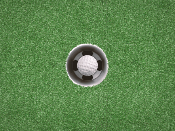 golfbal in golf cup op groen - Foto, afbeelding