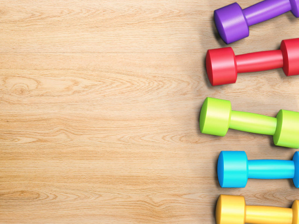 colorful dumbbells on wooden floor - Photo, Image
