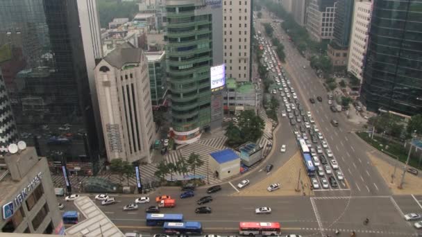 View from above to the traffic at the street and modern buildings of the Gangnam district in Seoul, Korea. - Felvétel, videó