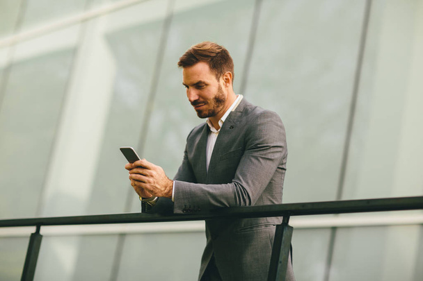 Young modern businessman with smartphone  - Photo, Image