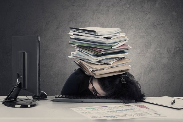 Woman sleeps on desk with documents  - Zdjęcie, obraz