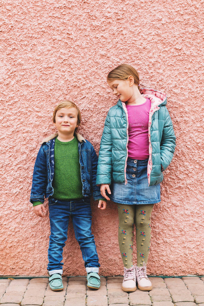 Fashion portrait of adorable kids wearing warm jackets and shoes - Photo, Image