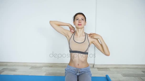 Young woman doing yoga exercise asana on mat indoor - Кадри, відео