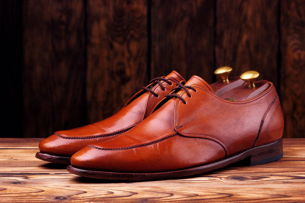 Fashionable leather derby shoes for men on wooden background - Foto, Imagem