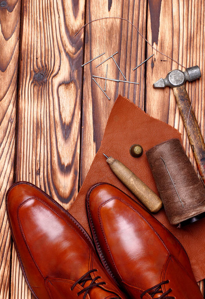Fashion derby shoes handmade and shoemaker tools awl, nails, skien of thread .Wooden background.copy space.top view.Concept cobbler - Foto, Bild