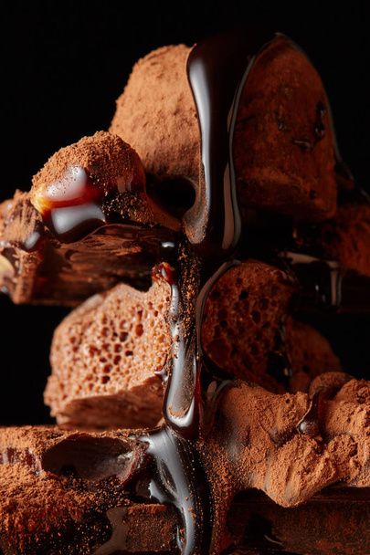 syrup pouring onto dark chocolate - Foto, afbeelding