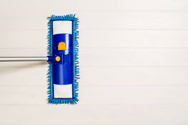 Cleaning floor with mop top view on white wooden background - Fotoğraf, Görsel