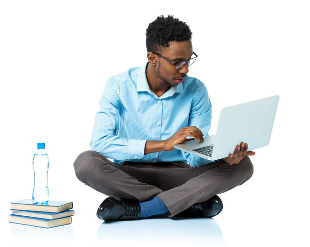African american college student sitting with laptop on white - Zdjęcie, obraz