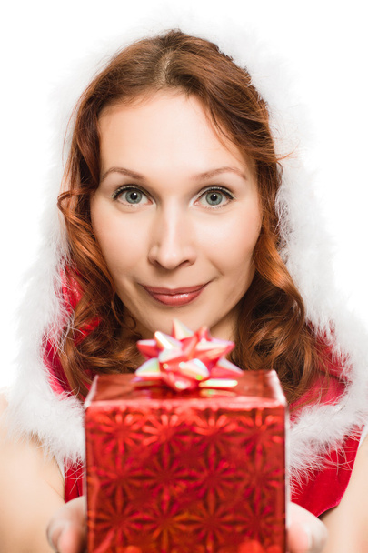 Attractive woman in Christmas dress hands a present - Valokuva, kuva