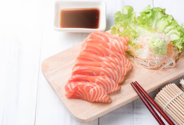 salmon sashimi on wood block and white wood background, Japaness - Photo, Image