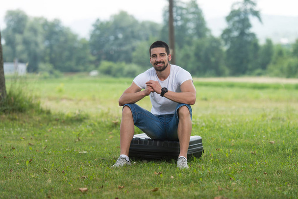 Man Sitting On Suitcase of Drone - Photo, image