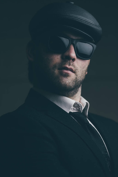 man in sunglasses and a leather cap - Fotó, kép