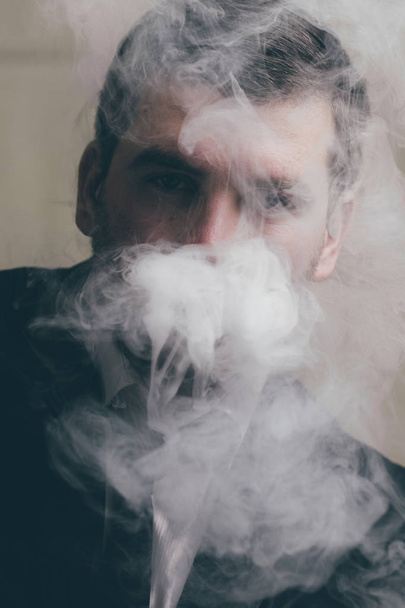 Mysterious businessman in smoke - Valokuva, kuva