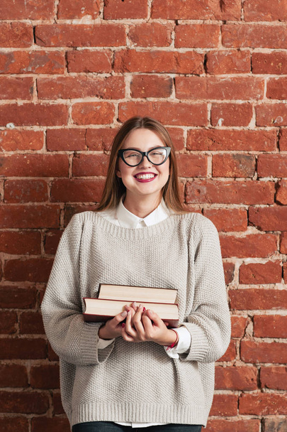 Smiling girl student with books free space - Foto, imagen