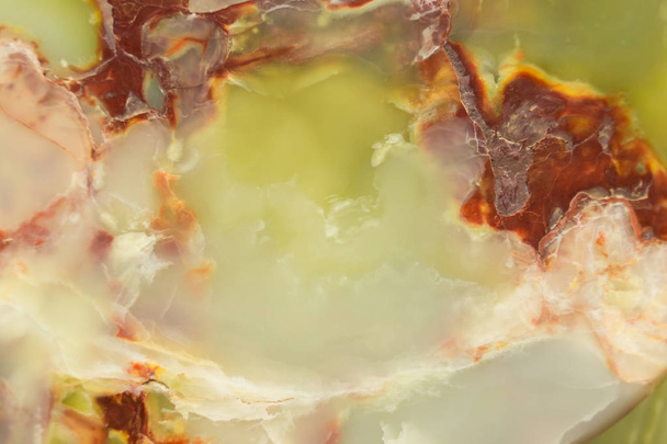 Lightened slices marble onyx. Horizontal image. Warm green colors. Beautiful close up background - Photo, Image