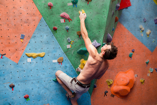 Handsome muscular naked shirtless climber at gym wall - Photo, Image