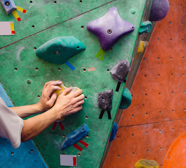 Muscular Climber hand on the bouldering climbing wall grip close-up - Фото, зображення