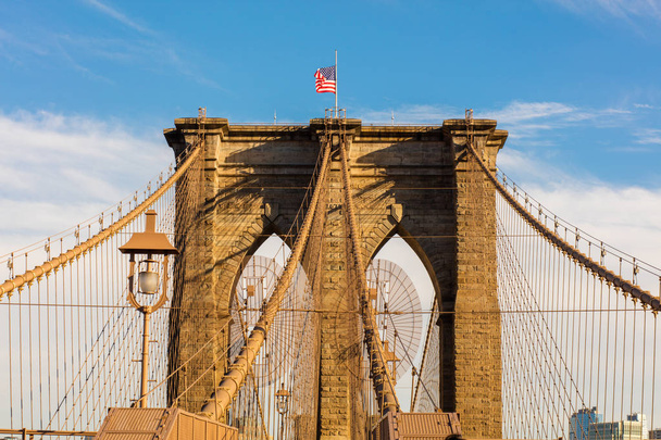 brooklyn bridge with united states flag on top - Foto, afbeelding