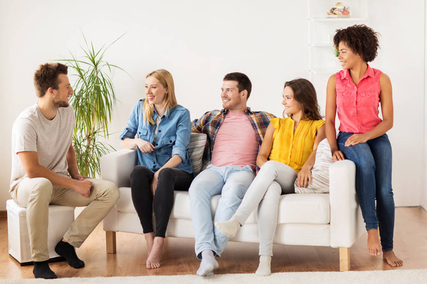 group of happy friends talking at home - Photo, image