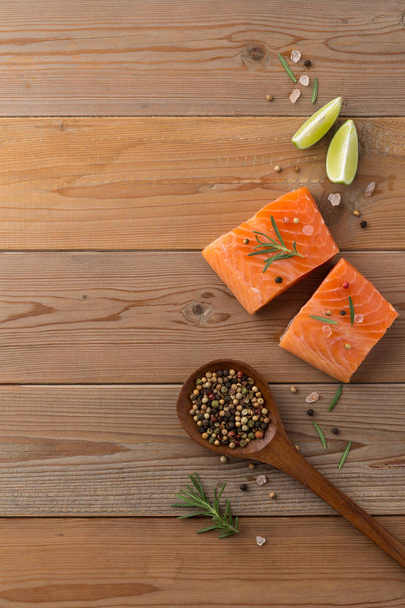 Beautiful composition of fresh salmon fillet with rosemary, salt - Photo, Image