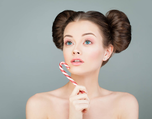 Beautiful Model Woman with Candy. Perfect Girl Looking Up - 写真・画像