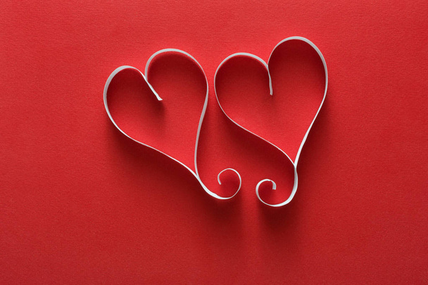 Valentine day background, handmade paper hearts on red - 写真・画像
