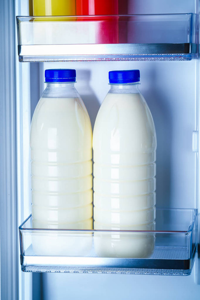 Bottles of milk in the fridge - Photo, image