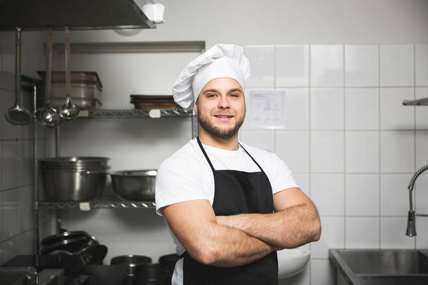 Happy chef standing in kitchen - Φωτογραφία, εικόνα