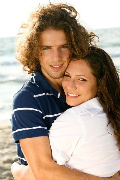Adorable couple embracing at beach - Photo, Image