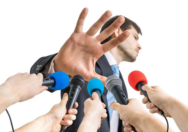 Many microphones in front of politician who shows no comment gesture. - Foto, Imagem
