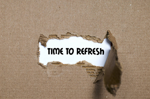The word time to refresh appearing behind torn paper - Photo, Image