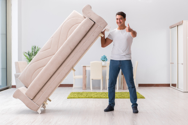 Man moving furniture at home - Fotoğraf, Görsel
