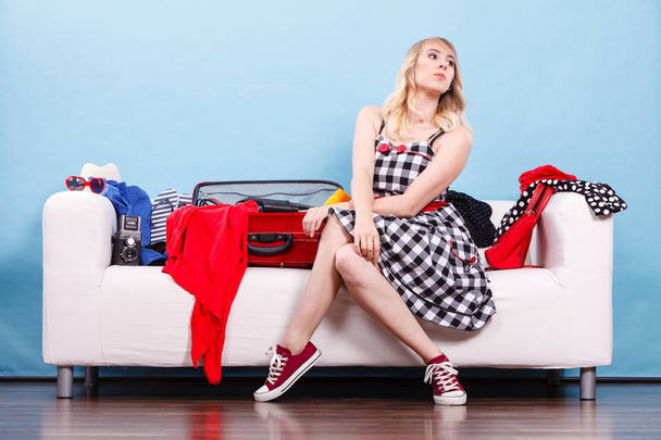 Woman choosing things to pack into suitcase - Φωτογραφία, εικόνα