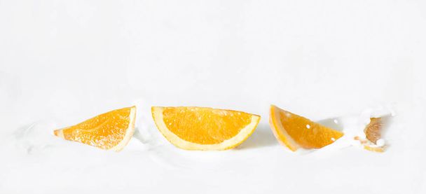 Sliced citrus fruits (oranges) in the milk - Fotografie, Obrázek