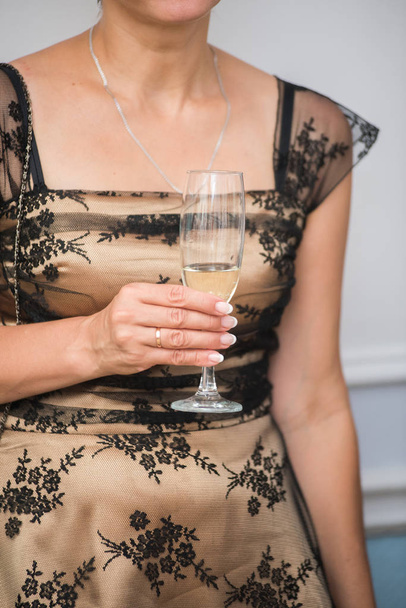 Woman holding glass champagne or sparkling wine - Fotoğraf, Görsel