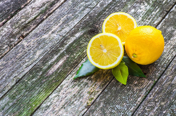Pile of lemons on wooden table - Zdjęcie, obraz
