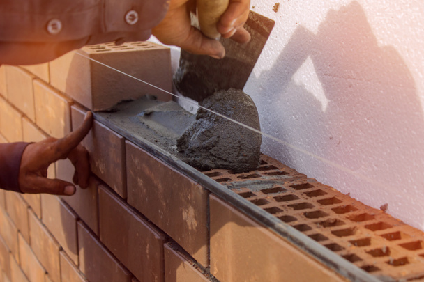 Bricklayer lays the mortar for laying brick. construction work - Foto, Imagem