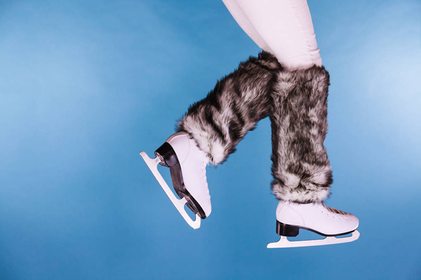 Woman legs wearing ice skates fur socks, skating  - Valokuva, kuva