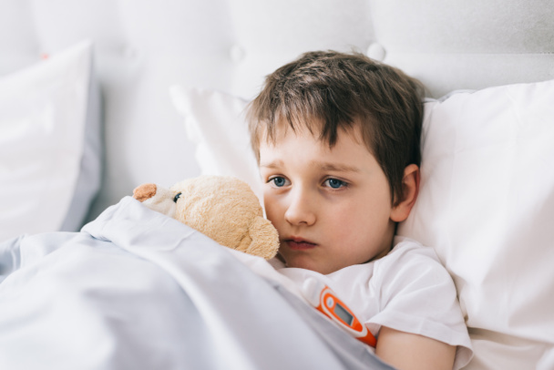 Sick little child with temperature in bed. - Photo, Image
