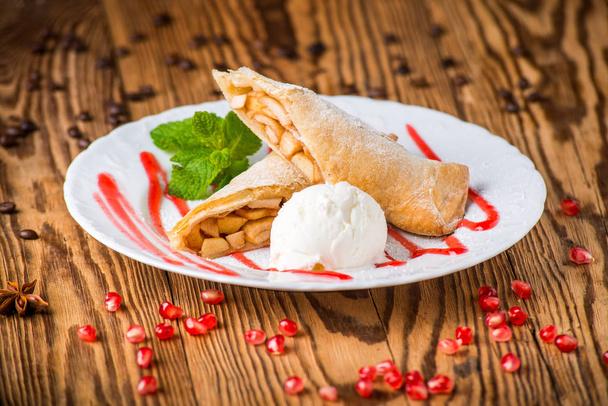 Apple strudel sprinkled with powdered sugar and ice creams - Photo, Image