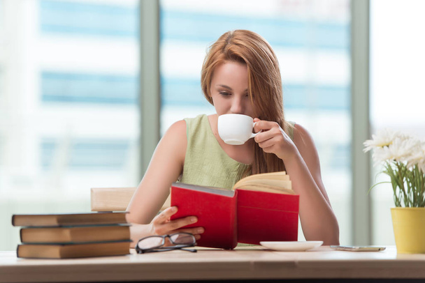 Young student preparing for exams drinking tea - 写真・画像