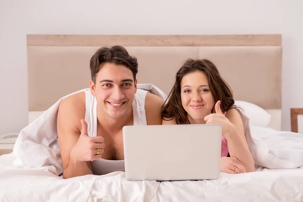 Funny concept with wife and husband in bed - Photo, Image