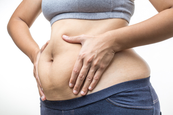 obézní žena s ruka drží tuk břicho - Fotografie, Obrázek