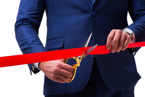 Businessman cutting red ribbon isolated on white - Foto, Bild