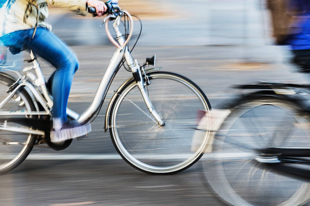 bicycle riders in city traffic in motion blur - Photo, image