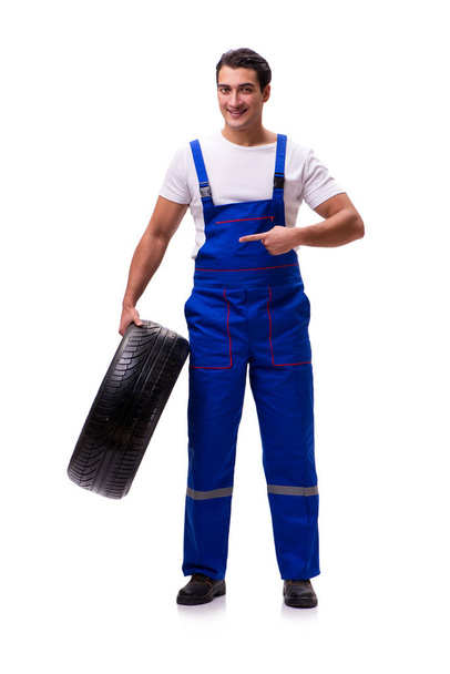 Handsome tyre repairman isolated on white - Фото, изображение
