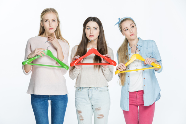 Women with colorful hangers - 写真・画像