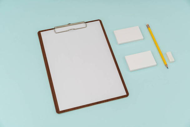 Clip board, paper,pencil  and business card on blue background . - Foto, Bild