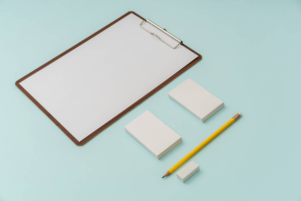 Clip board, paper,pencil  and business card on blue background . - 写真・画像