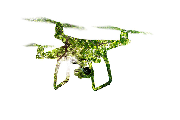 Double exposure. Hovering drone taking pictures of green trees. - Photo, Image